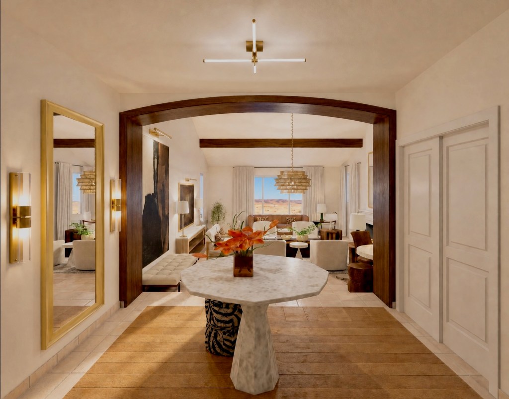 A stylish interior view of a modern living area featuring a marble dining table, wooden flooring, elegant lighting fixtures, and a large window with a desert landscape visible outside.